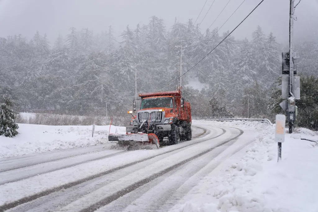 A plow clears snow on Mount Baldy Road in the town of Mount Baldy, Calif., on Feb. 24, 2023. (Allison Dinner/AFP via Getty Images)
