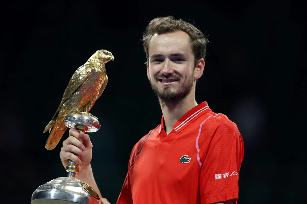 Daniil Medvedev of Russia celebrates on the podium with his trophy after winning his final match against Andy Murray of Great Britain in day six of Qatar ExxonMobil Open at Khalifa International Tennis and Squash Complex, in Doha, Qatar, on Feb. 25, 2023. (Mohamed Farag/Getty Images)
