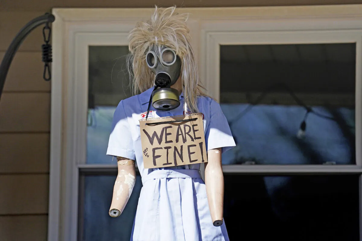 A resident displays a mannequin on their porch in East Palestine, Ohio, as cleanup from the Feb. 3 Norfolk Southern train derailment continues, on Feb. 24, 2023. (Matt Freed/AP Photo)