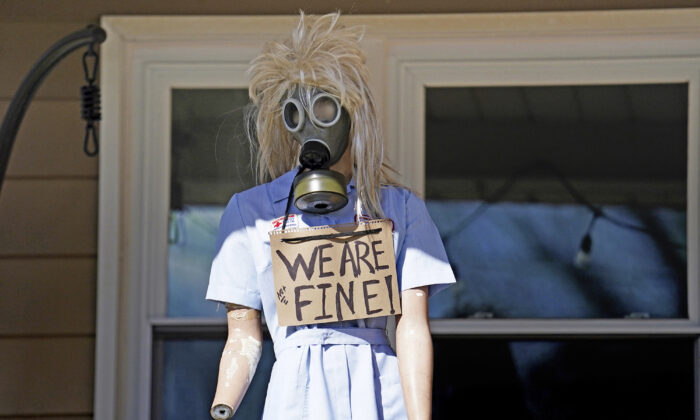 A resident displays a mannequin on their porch in East Palestine, Ohio, as cleanup from the Feb. 3 Norfolk Southern train derailment continues, on Feb. 24, 2023. (Matt Freed/AP Photo)
