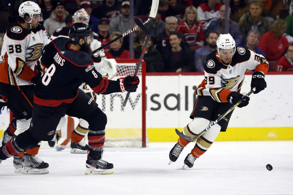 Carolina Hurricanes' Brent Burns (8) loses control of the puck to Anaheim Ducks' Sam Carrick (39) during the first period of an NHL hockey game in Raleigh, N.C., on Feb. 25, 2023. (Karl B DeBlaker/AP Photo)