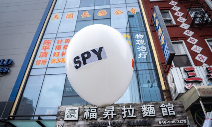 A balloon is held at a press conference and rally in front of the America ChangLe Association highlighting Beijing's transnational repression, in New York City on Feb. 25, 2023. A now-closed overseas Chinese police station is located inside the association building. (Samira Bouaou/The Epoch Times)