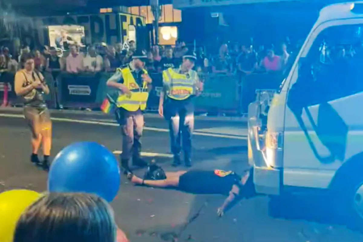 Australian Senator Lidia Thorpe, a former greens who is now independent, temporarily halts the Sydney Mardi Gras Parade by lying in front of a vehicle before she was asked to leave by police on Feb. 25, 2023. (AAP Image/Alex Day)