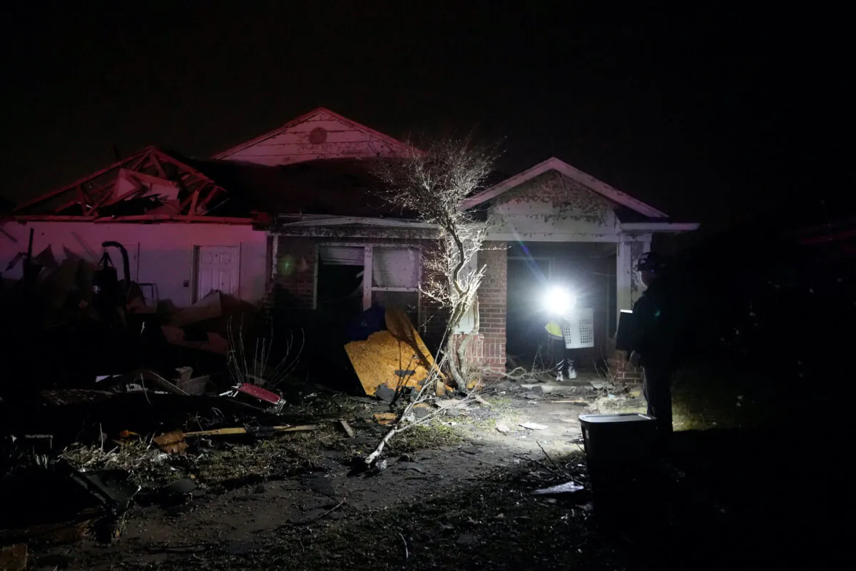 Residents work to recover items from a home that was hit by a tornado in Norman, Okla., on Feb. 27, 2023. (Nick Oxford/Reuters)