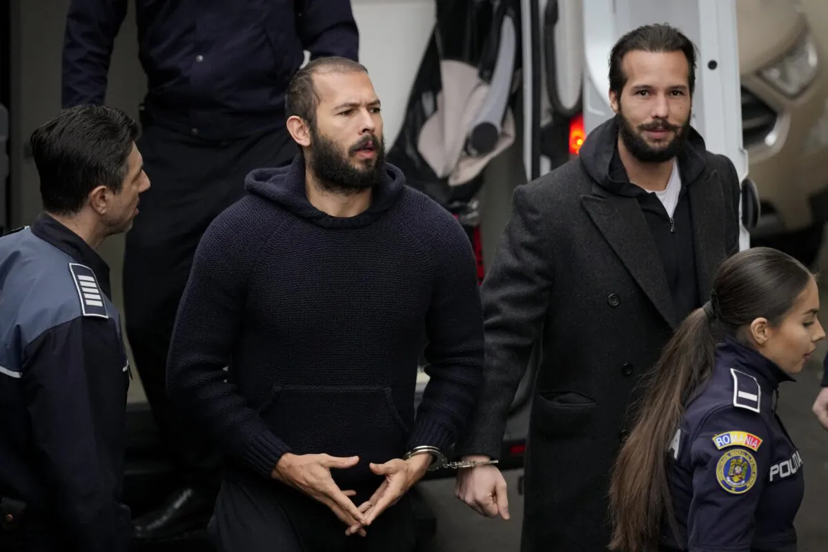 Police officers escort Andrew Tate (C) handcuffed to his brother Tristan Tate to the Court of Appeal in Bucharest, Romania, on Feb. 27, 2023. (Andreea Alexandru/AP Photo)