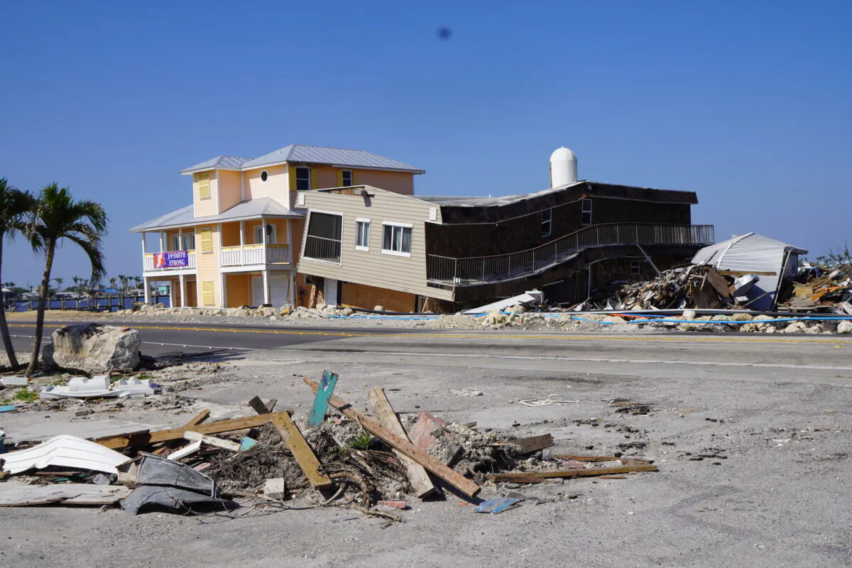 Pine Island Road before the Matlacha Pass Bridge is lined with derelict buildings, including condos and businesses, that have not yet been demolished five months after they were slammed by Hurricane Ian. (John Haughey/The Epoch Times)