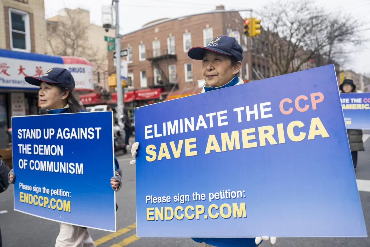 Falun Gong practitioners walk in a parade in Brooklyn, N.Y., highlighting the Chinese regime's persecution of their faith on Feb. 26, 2023.(Chung I Ho/The Epoch Times)