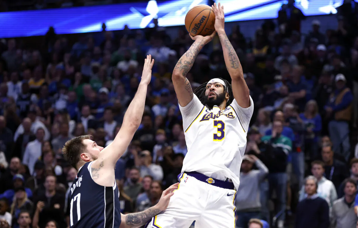 Anthony Davis (3) of the Los Angeles Lakers scores a basket over Luka Doncic (77) of the Dallas Mavericks in the second half at American Airlines Center in Dallas on Feb. 26, 2023. (Ron Jenkins/Getty Images)