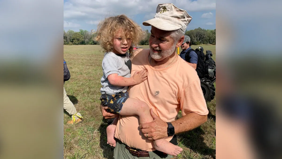 Former U.S. Marine Roy Link carries 2-year-old Joshua “JJ” Rowland after the boy was found in the woods in Hernando County, Fla. (Courtesy of Hernando County Sheriff's Office Facebook)