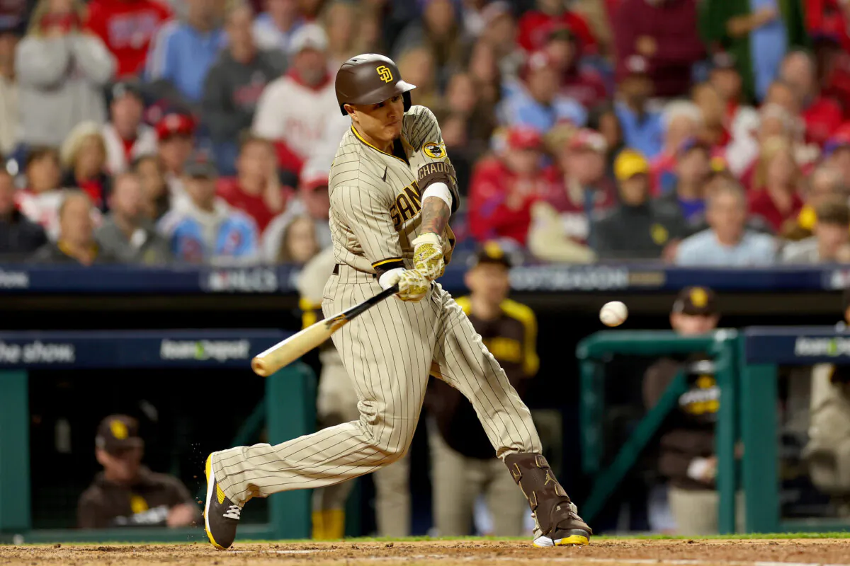Manny Machado (13) of the San Diego Padres hits a single during the seventh inning against the Philadelphia Phillies in game four of the National League Championship Series at Citizens Bank Park in Philadelphia on Oct. 22, 2022. (Mike Ehrmann/Getty Images)