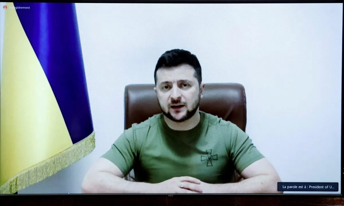 Ukrainian President Volodymyr Zelenskyy appears on a screen as he addresses French lawmakers via video link at the National Assembly in Paris on March 23, 2022. (Benoit Tessier/Reuters)
