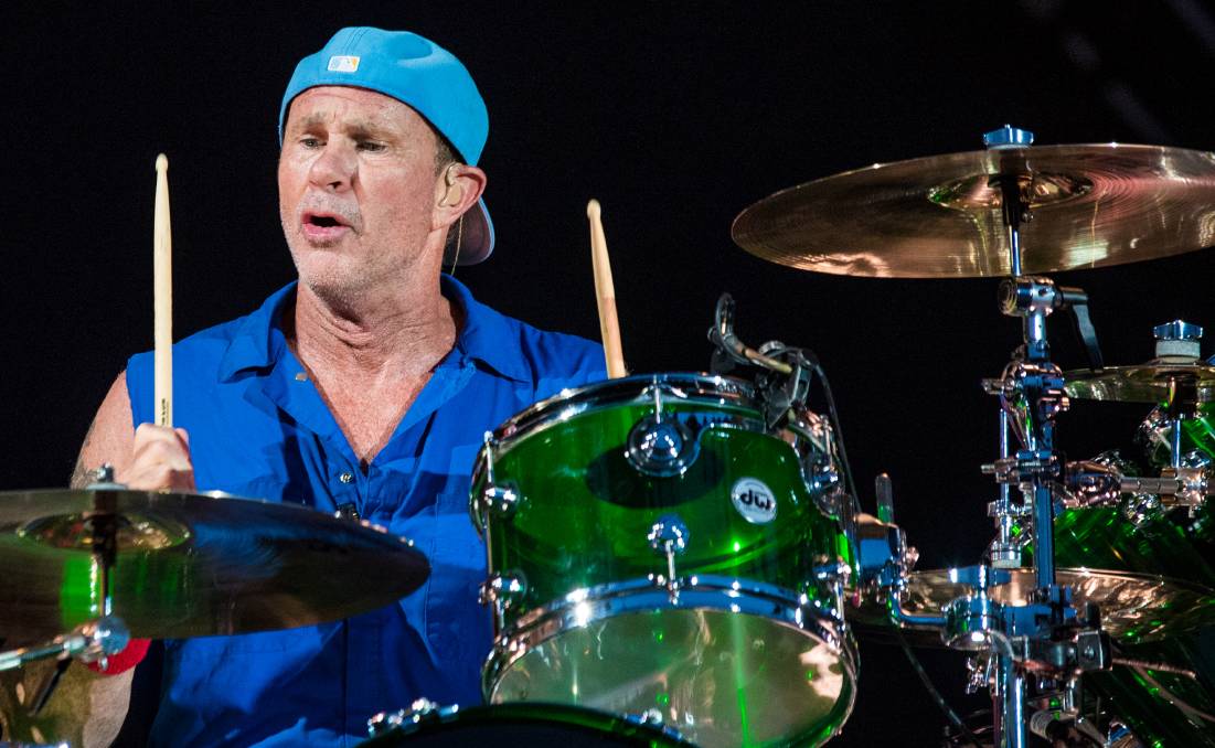 drummer in blue shirt and hat with green drums in COUNT ME IN 