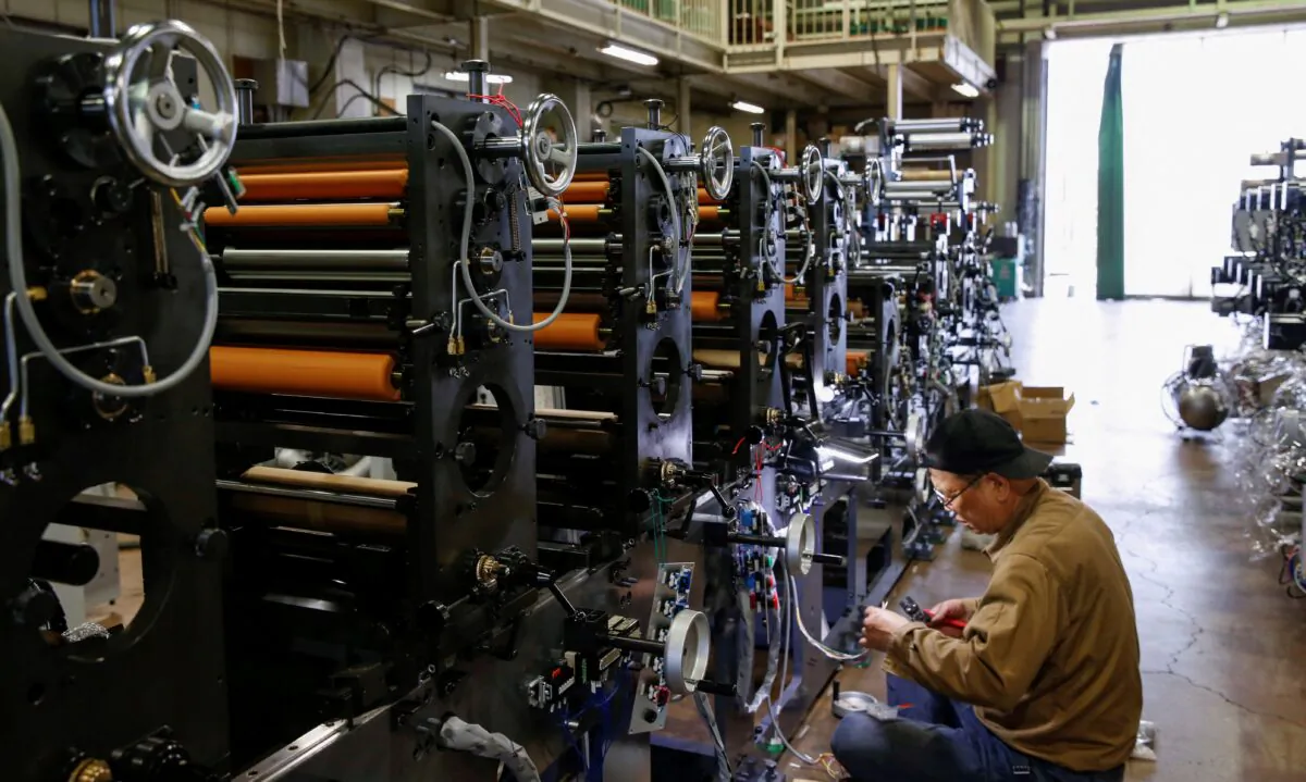 A worker checks machinery at a factory in Higashiosaka, Japan, on June 23, 2022. (Sakura Murakami/Reuters)