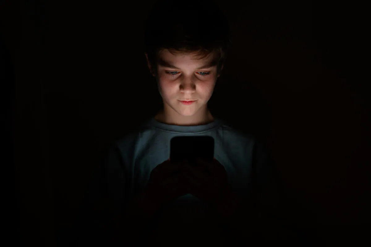 A teenager looks at a phone in London on Jan. 17, 2023. (Leon Neal/Getty Images)