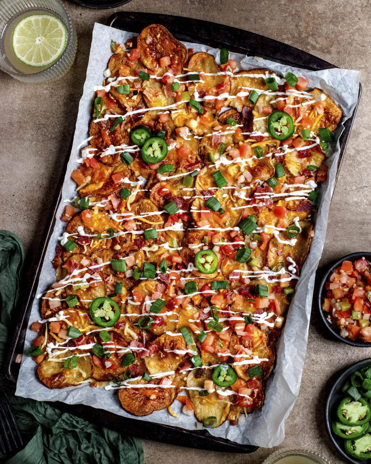 Thin-sliced potatoes are roasted until crisp, then topped with all your favorite nacho toppings in this comfort food twist. (Courtesy of TheKitchn.com)