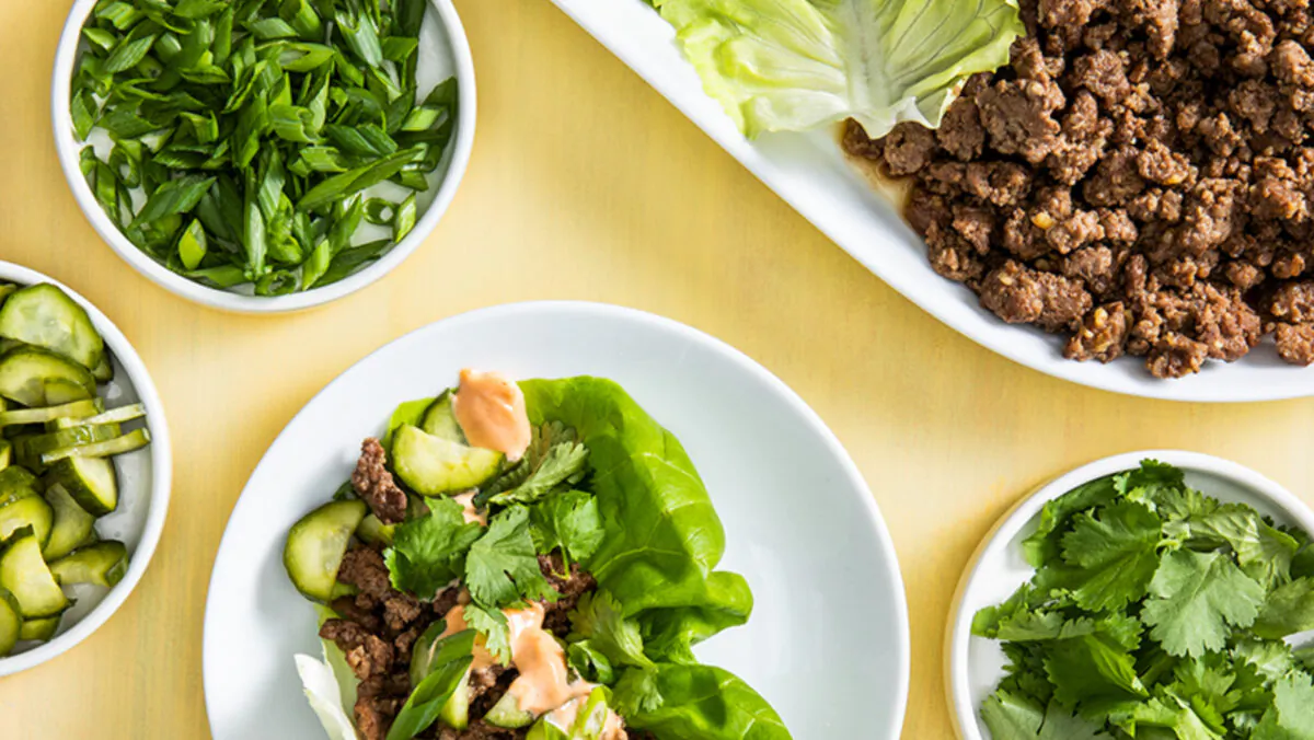 This hands-on meal is packed with tender beef, tangy pickles, fresh herbs, spicy sauce, and crunchy lettuce. (America's Test Kitchen/TNS)