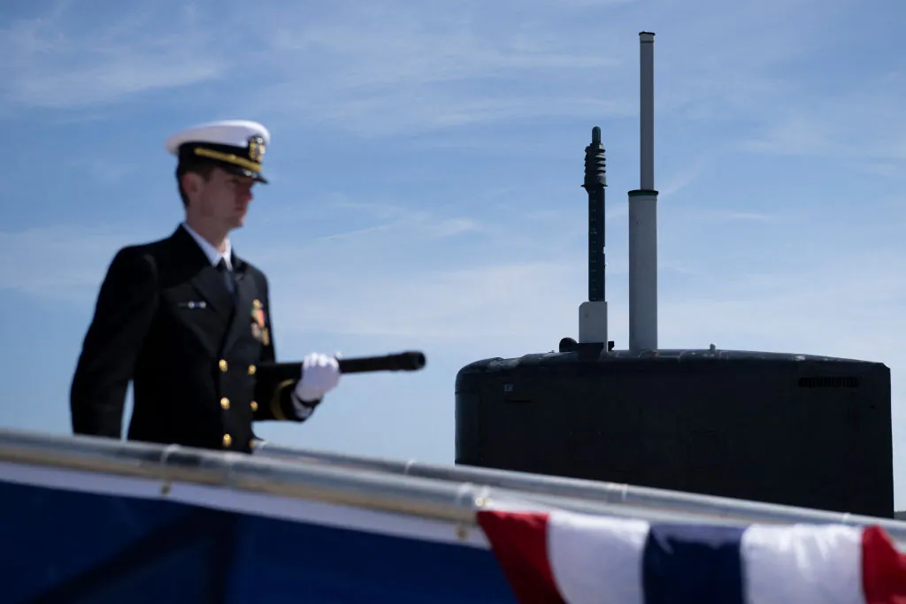 A member of the crew's first watch comes onboard during the commissioning commemoration ceremony for the Virginia-Class submarine USS Delaware at the Port of Wilmington in Wilmington, Delaware, on April 2, 2022. (Brendan Smialowski/AFP via Getty Images)