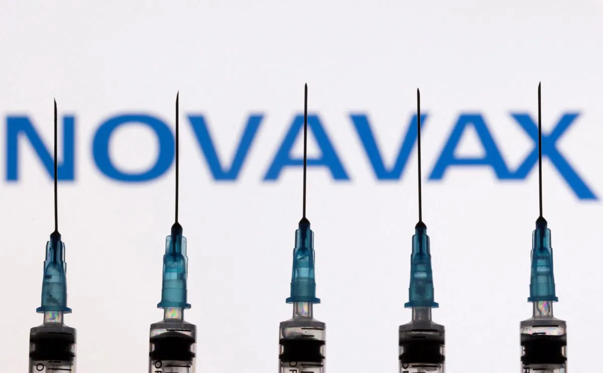 Syringes with needles are seen in front of a displayed Novavax logo in an illustration taken on Nov. 27, 2021. (Dado Ruvic/Illustration/Reuters)