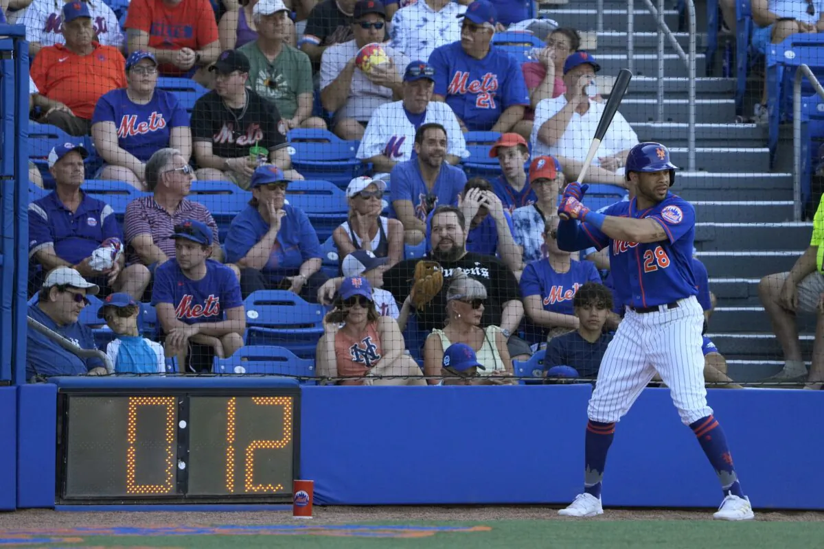 New York Mets' Tommy Pham stands in the on-deck circle as a pitch clock counts down during the sixth inning of a spring training baseball game against the Washington Nationals in Port St. Lucie, Fla., on Feb. 26, 2023. (Jeff Roberson/AP Photo)