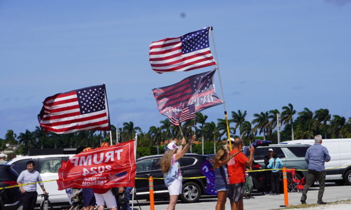 A stalwart cadre of 'Bridge People' wave flags, sing patriotic songs, and pray on the Southern Boulevard Bridge near Mar-a-Lago in Palm Beach, Fla., on March 31, 2023. (John Haughey/The Epoch Times)