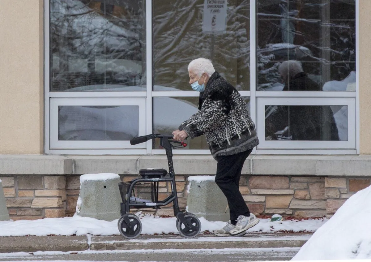 A woman walks outside a long-term care home in Barrie, Ont. on Jan. 18, 2021. (The Canadian Press/Frank Gunn)
