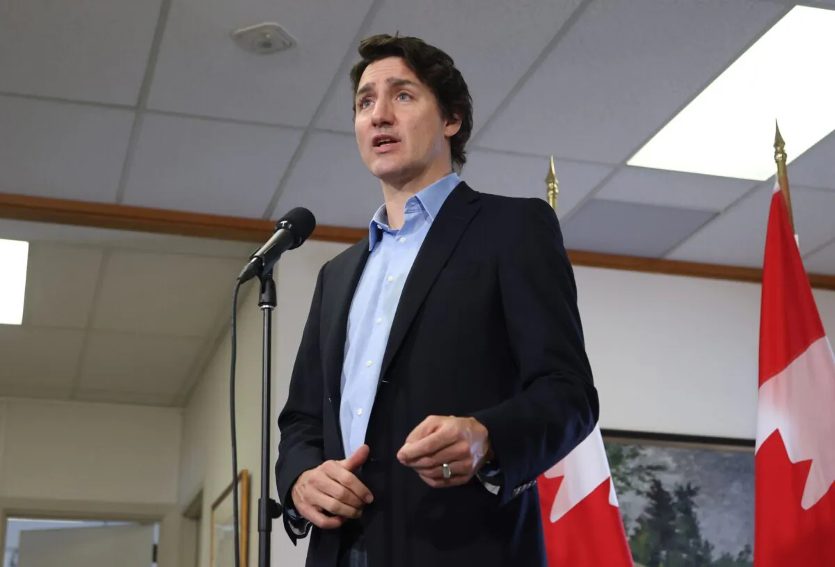 Prime Minister Justin Trudeau speaks to the media in Ottawa before boarding a flight to the Yukon on Feb. 12, 2023. (Patrick Doyle/The Canadian Press)