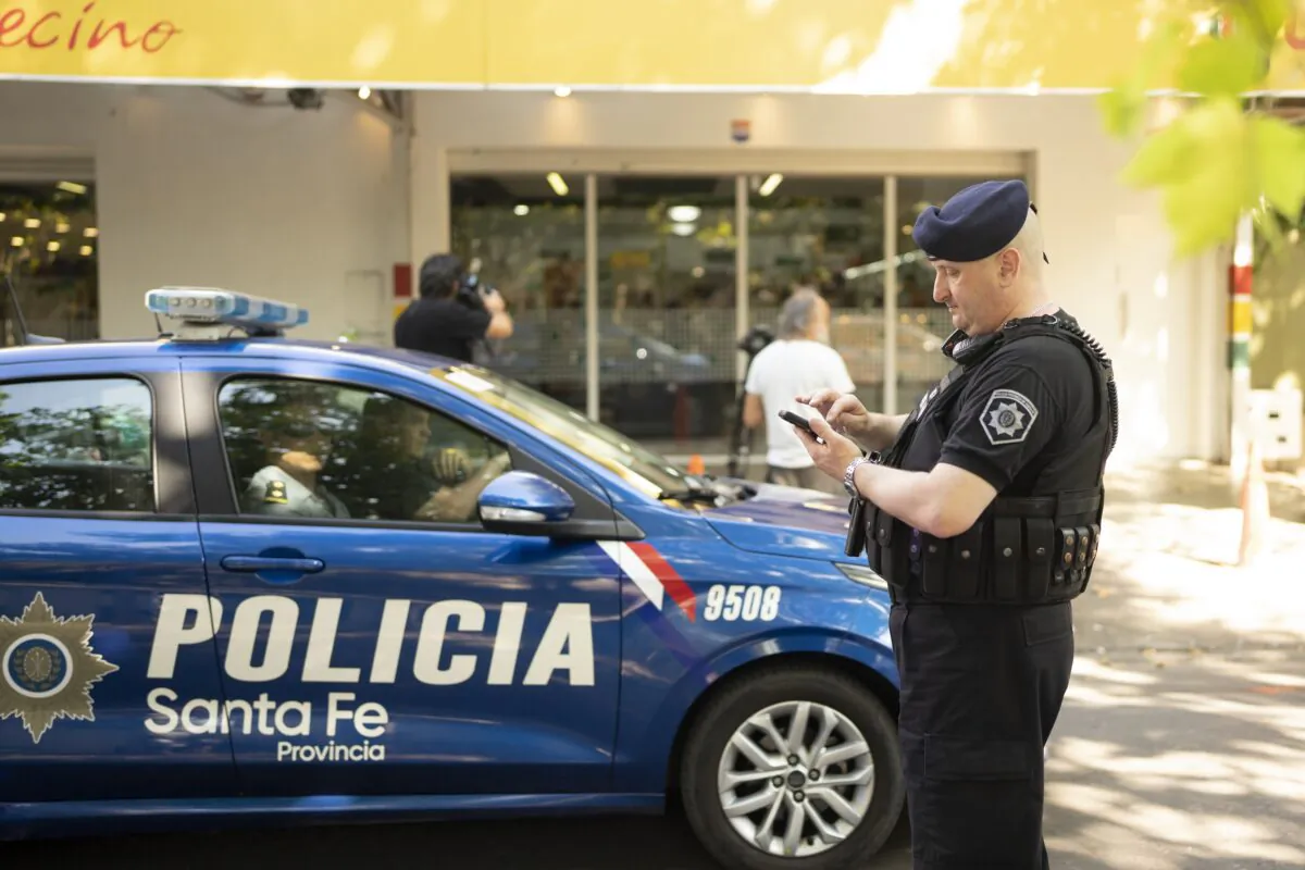 Police gather outside the Unico supermarket, a grocery chain owned by soccer player Lionel Messi's in-laws, after it was shot at in Rosario, Argentina, on March 2, 2023. (Sebastian Lopez Brach/AP Photo)