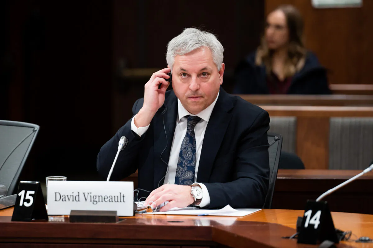 Director of the Canadian Security Intelligence Service David Vigneault adjusts a translation aid as he waits to appear before the Special Committee on Canada-People's Republic of China Relationship on Parliament Hill in Ottawa on Feb. 6, 2023. (The Canadian Press/Spencer Colby)