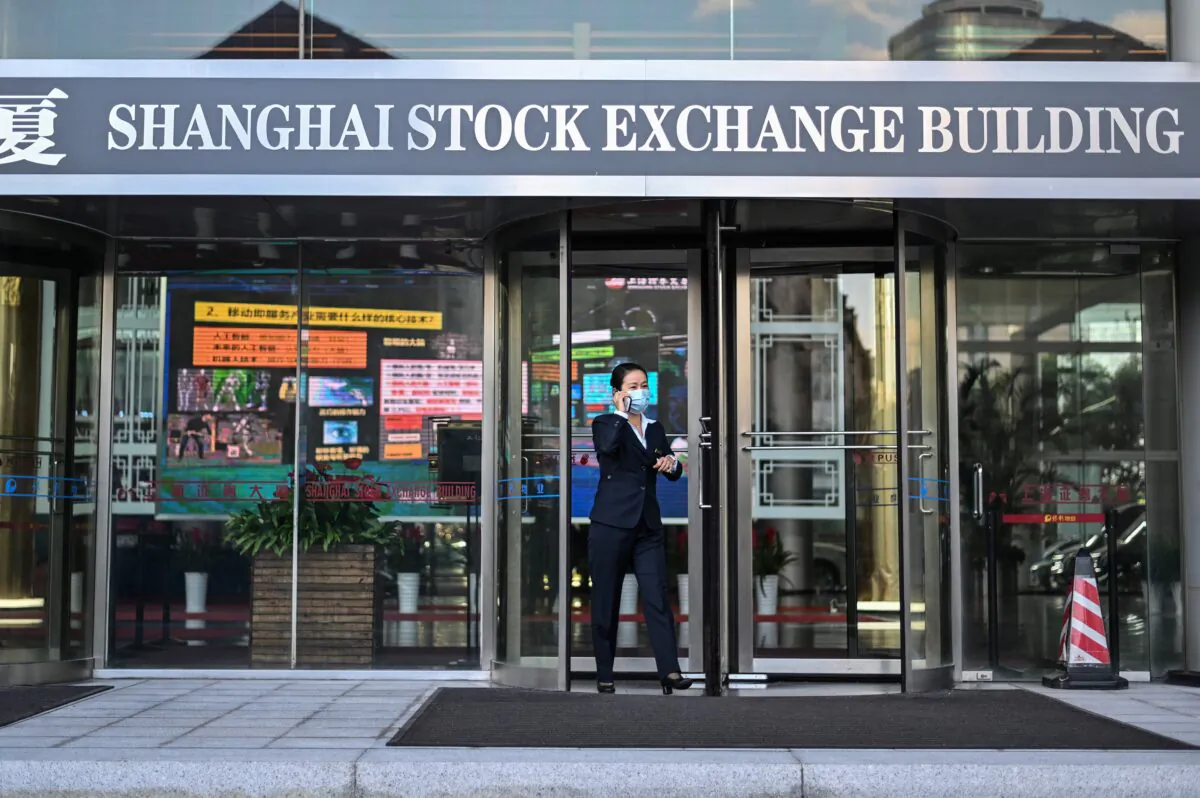 A woman leaves the Stock Exchange building in Shanghai, China, on Nov. 4, 2020. (Hector Retamal/AFP via Getty Images)