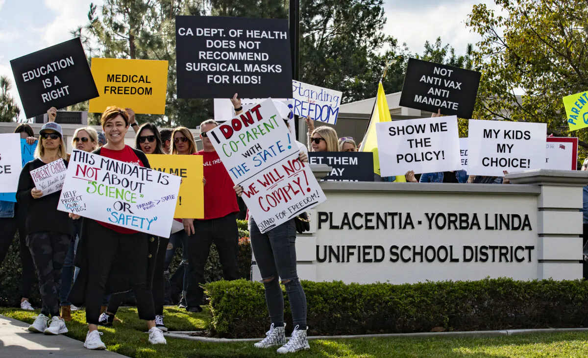 Parents and students gather in protest of school district policies at the Placentia Yorba Linda Unified School District offices in Placentia, Calif., on Jan. 18, 2022. (John Fredricks/The Epoch Times)
