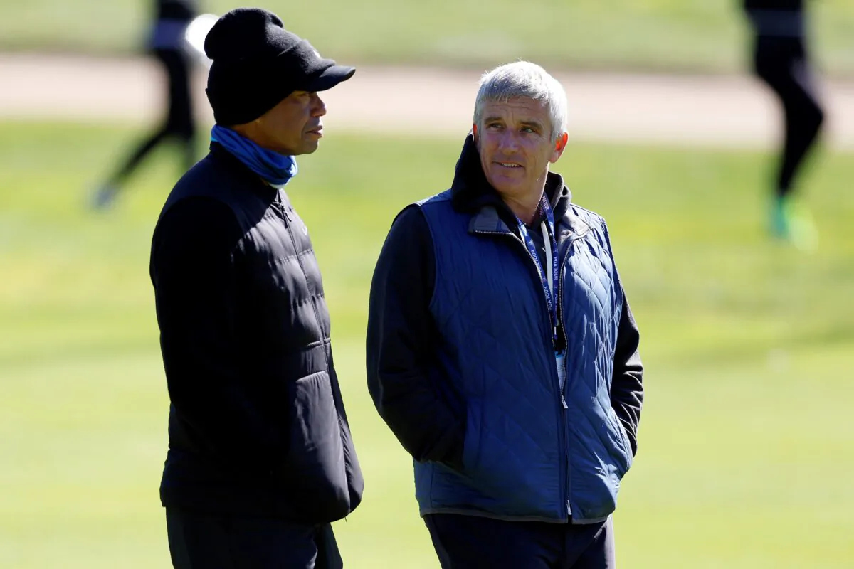 Tiger Woods(L), talks to PGA Commissioner Jay Monahan on the 15th hole during the pro-am of the Genesis Invitational golf tournament at Riviera Country Club, in the Pacific Palisades area of Los Angeles on Feb. 15, 2023. (Ryan Kang/ AP Photo)