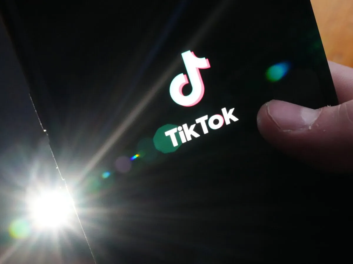 The TikTok startup page is displayed on an iPhone in Ottawa on Feb. 27, 2023. (The Canadian Press/Sean Kilpatrick)