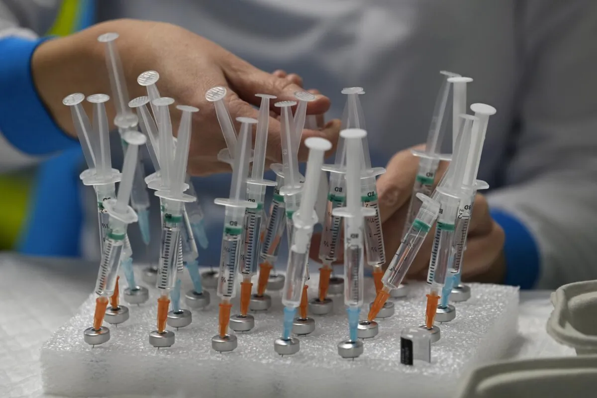 A nurse prepares vaccines in the Wizink Center, used for COVID-19 vaccinations in Madrid on Dec. 1, 2021. (Paul White/AP Photo)