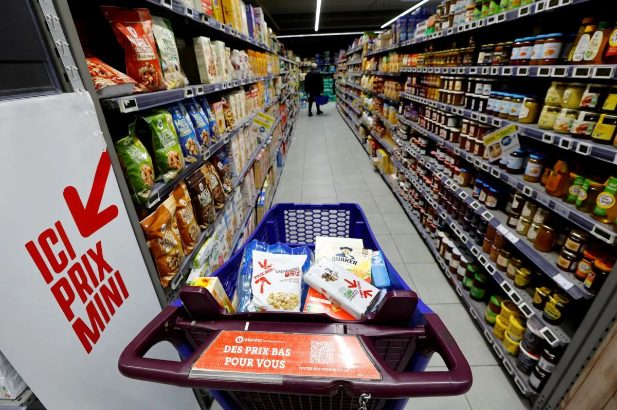 A sign reading "Low prices for you" is seen on a shopping trolley in a supermarket in Nice, France, on March 1, 2023. (Eric Gaillard/Reuters)