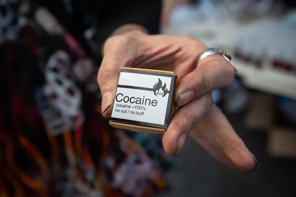 Martin Steward holds cocaine he received from the Drug User Liberation Front, in Vancouver, B.C., on April 14, 2021. (The Canadian Press/Darryl Dyck)