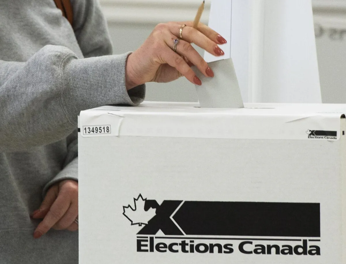 A voter casts her ballot in the advance polls for the 2021 federal election, in Chambly, Que., on Sept. 10, 2021. (The Canadian Press/Ryan Remiorz)