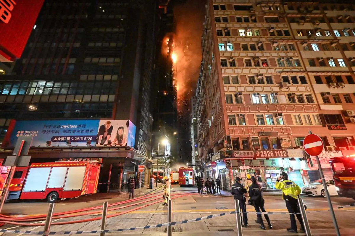 A fire burns at a high-rise building under construction in the Tsim Sha Tsui district in Hong Kong on March 3, 2023. (Peter Parks/AFP via Getty Images)