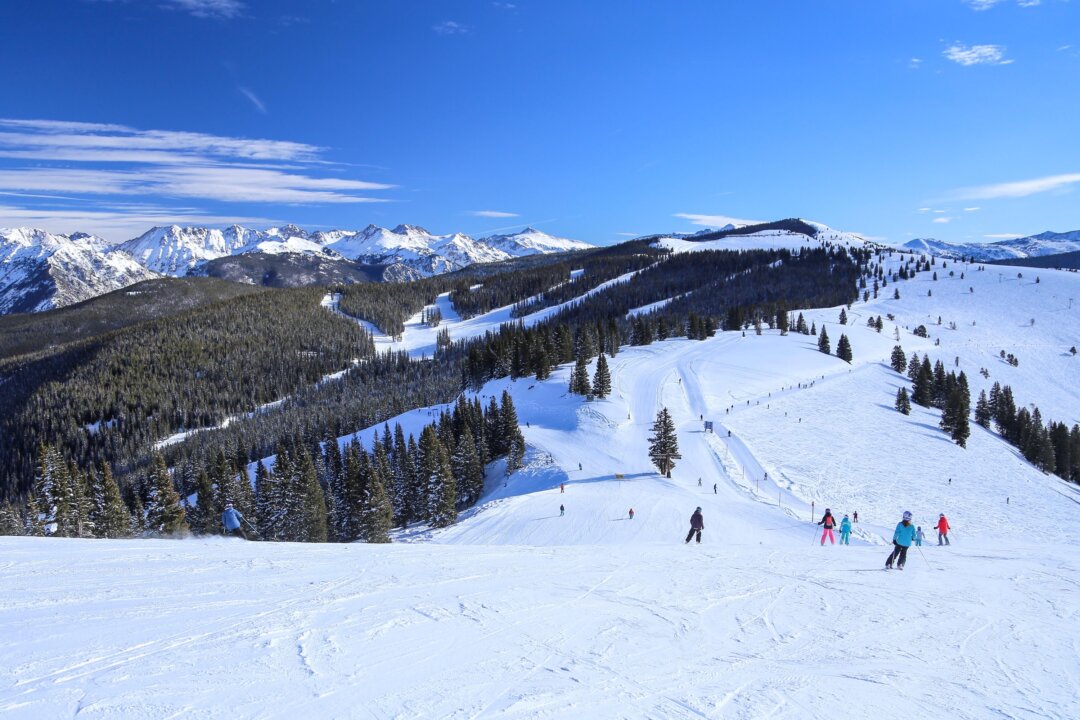 People ski down the mountains of Vail esort in Colorado on a winter day. Last season, Colorado Vail Resorts reported that it sold 2.1 million Epic passes—” 700,000 more than the 2020-2021 season—” after discounting prices by 20%. (Dreamstime/TNS)