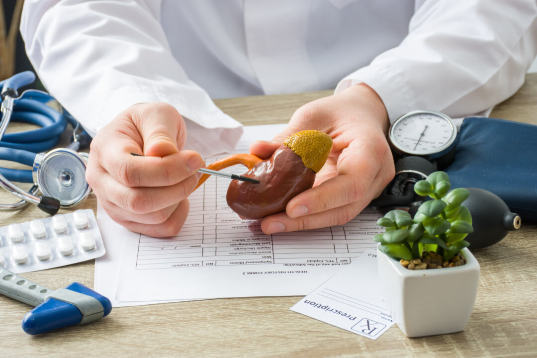 At doctors appointment physician shows to patient shape of kidney with focus on hand with organ. (Shutterstock)