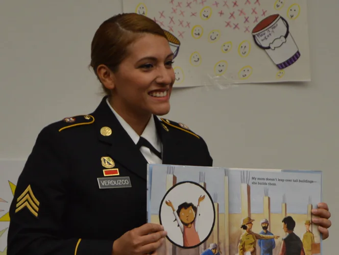 U.S. Army Reserve Sgt. Ana Verduzco with the 4th Sustainment Command (Expeditionary) reads "Hero Mom," by Melinda Hardin and Bryan Langdo, to children at Kinder Ranch Elementary, on Mar. 10, 2017. (U.S. Army Reserve photo by Maj. Brandon R. Mace)