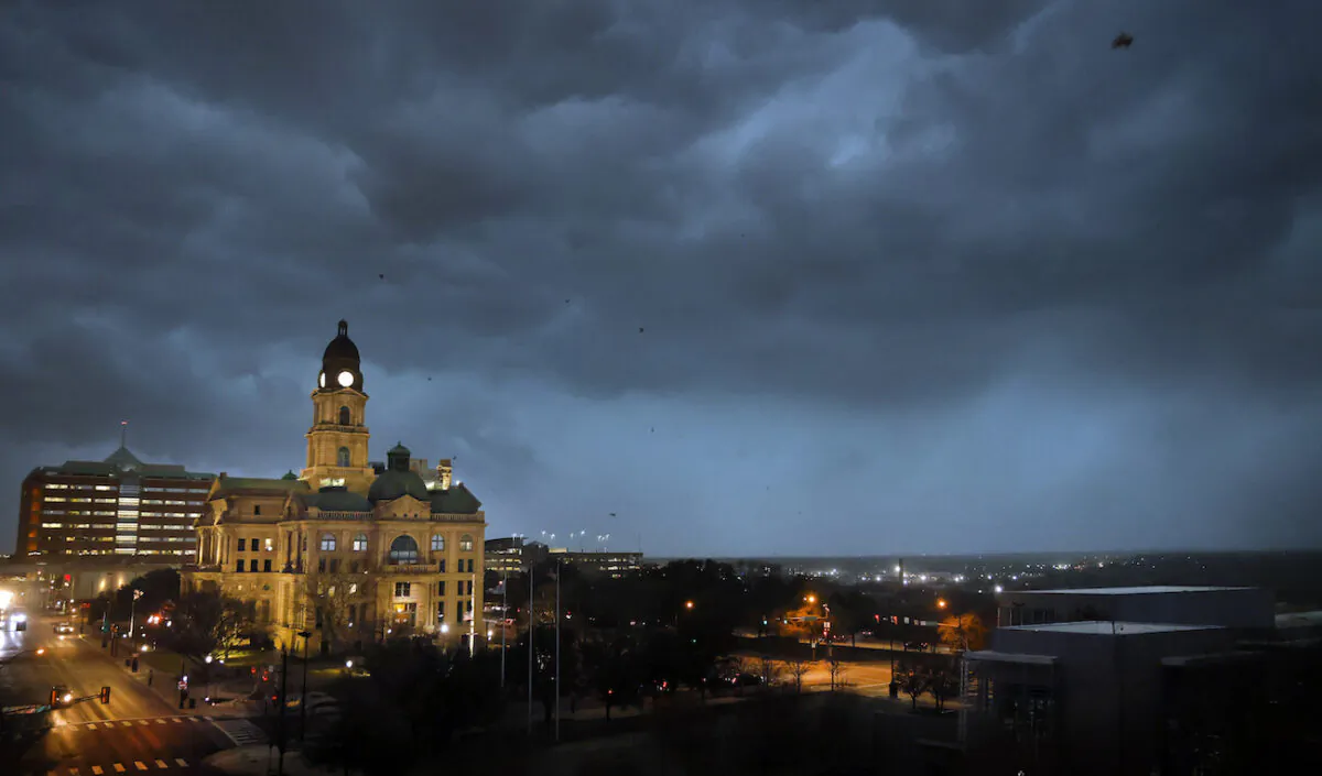 Debris flies through the air as howling winds accompanied by a line of storms approach the old Tarrant County Courthouse in downtown Fort Worth, Texas, on March 2, 2023. (Tom Fox/The Dallas Morning News via AP)