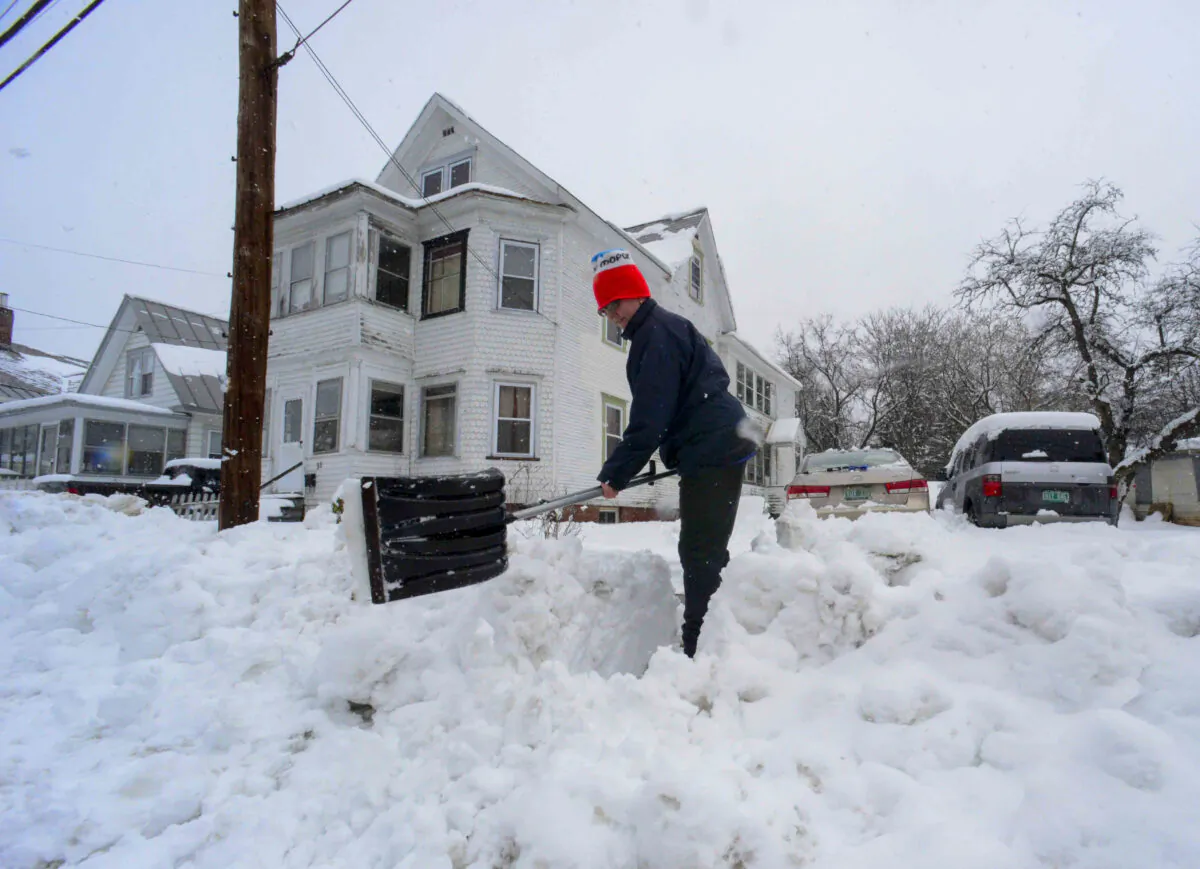 Rocio Franco shovels the snow from the open of her driveway in Bellow Falls, Windham County, Vt., on March 4, 2023. (Kristopher Radder/The Brattleboro Reformer via AP)