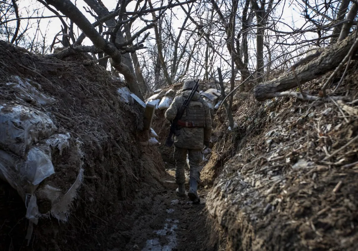 A Ukrainian service member is seen in a trench at a position outside the frontline town of Horlivka, in Donetsk region, Ukraine, on March 3, 2023. (Anna Kudriavtseva/Reuters)