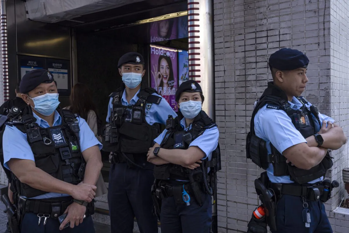 Police officers stand guard where a cancelled march for women's rights was scheduled to take place in Hong Kong, on March 5, 2023. (Louise Delmotte/AP Photo)
