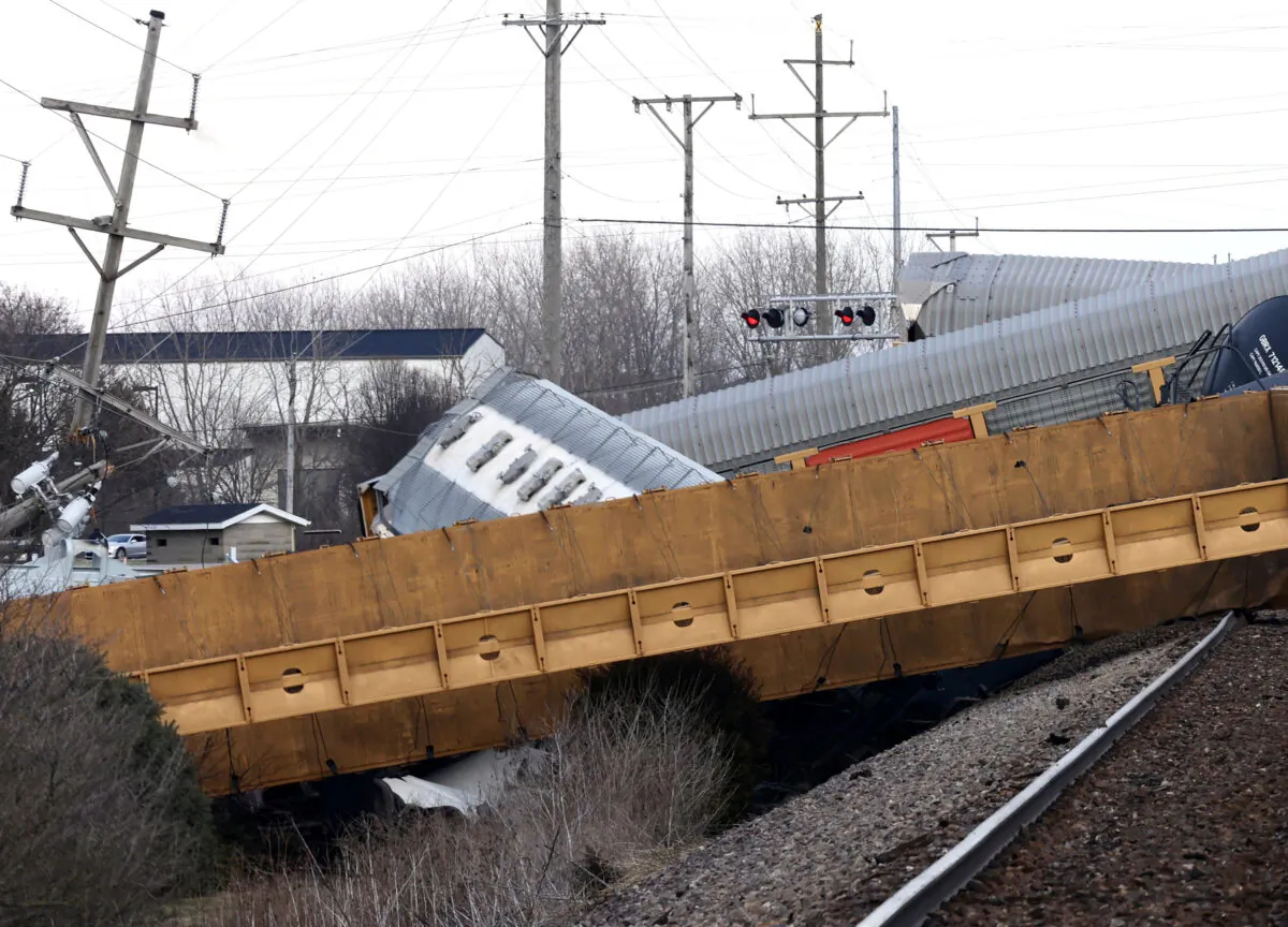 Multiple cars of a Norfolk Southern train lie toppled on one another after derailing at a train crossing with Ohio 41 in Clark County, Ohio, on March 4, 2023. (Bill Lackey/Springfield-News Sun via AP)
