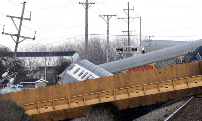 Multiple cars of a Norfolk Southern train lie toppled on one another after derailing at a train crossing with Ohio 41 in Clark County, Ohio, on March 4, 2023. (Bill Lackey/Springfield-News Sun via AP)