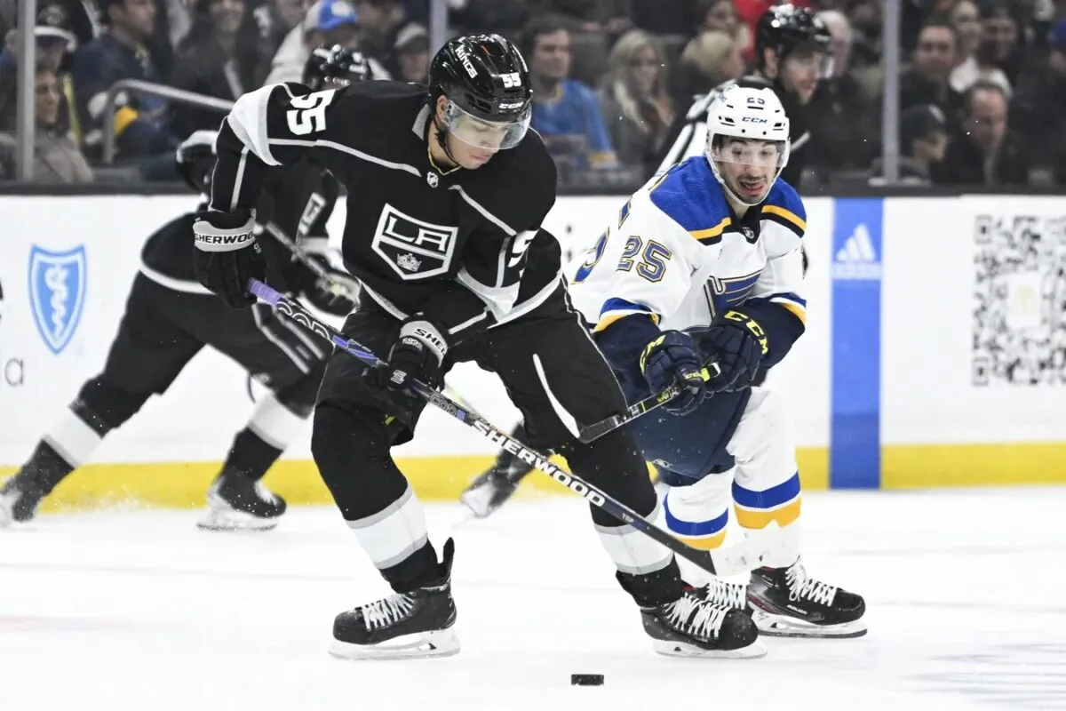 Los Angeles Kings center Quinton Byfield (55) moves the puck while pressured by St. Louis Blues center Jordan Kyrou (25) during the first period at Crypto.com Arena in Los Angeles on March 4, 2023. (Kelvin Kuo-USA TODAY Sports via Field Level Media)