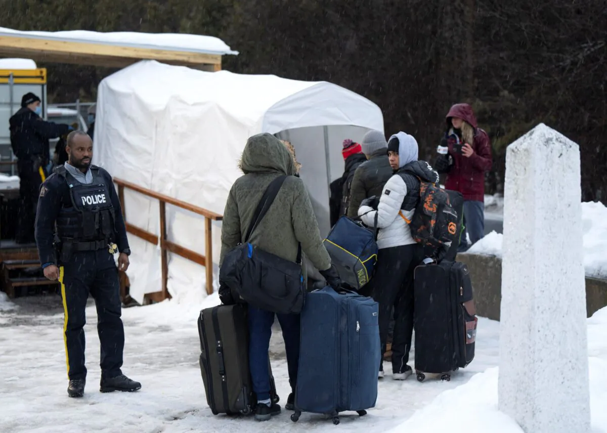 Asylum seekers cross the border at Roxham Road into Canada on Feb. 9, 2023. (The Canadian Press/Ryan Remiorz)