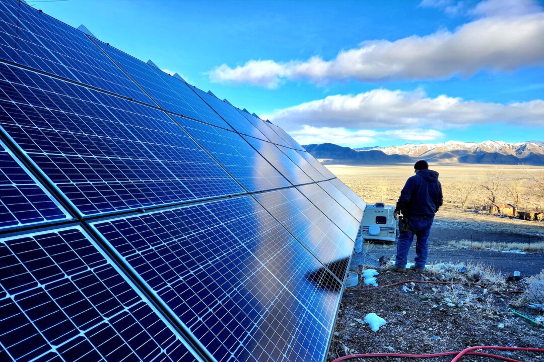 Brandon M, ranch manager at Fortitude Ranch Nevada, surveys the open range flanked by a solar panel on March 2, 2023. (Allan Stein/The Epoch Times)