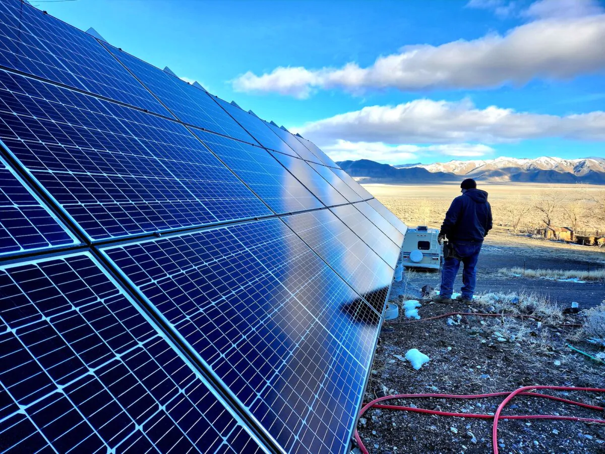 Brandon M, ranch manager at Fortitude Ranch Nevada, stands beside solar panels on Feb. March 2, 2023. (Allan Stein/The Epoch Times)